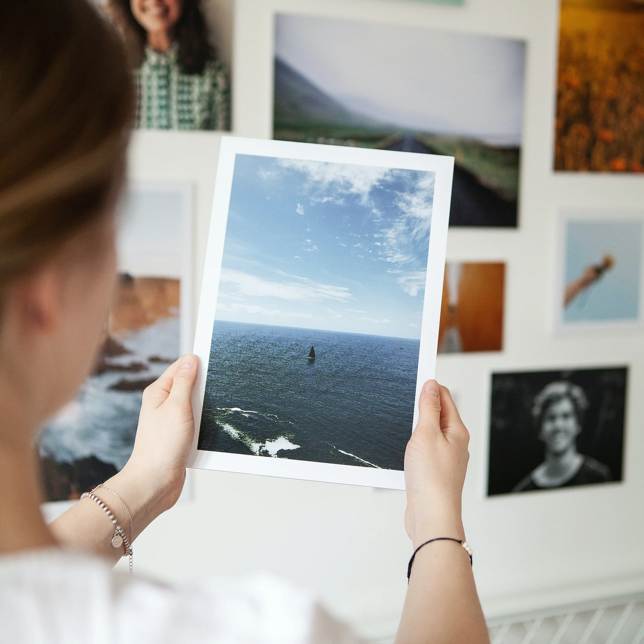Joyful girl holding a professionally printed photograph, showcasing the quality and cherished memories captured by Graination's expert photo printing services.