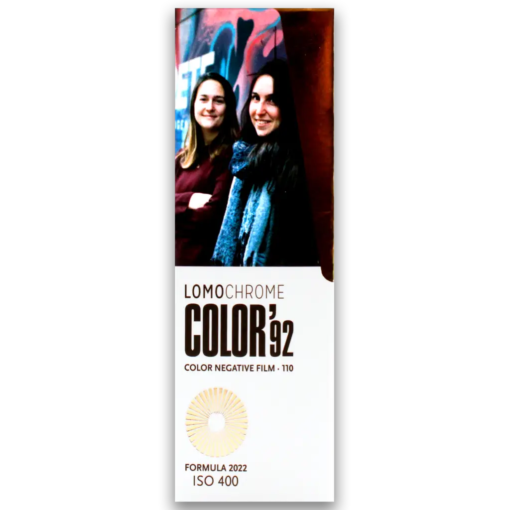 Packaging of LomoChrome Color '92 110 Color Negative Film with ISO 400, Formula 2022. Features two women smiling against a graffiti background, showcasing the film’s vibrant and retro color tones