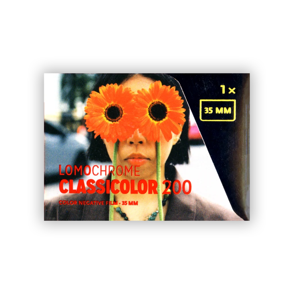 LomoChrome Classicolor 35mm colour negative film — a film frame of a portrait behind twin orange flowers